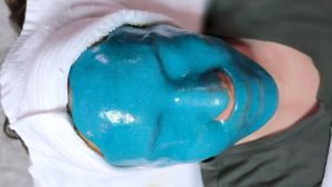 Professional esthetician applying Jelly Masks facial treatment — hydrating, cooling, and peel-off spa mask for refreshed skin.